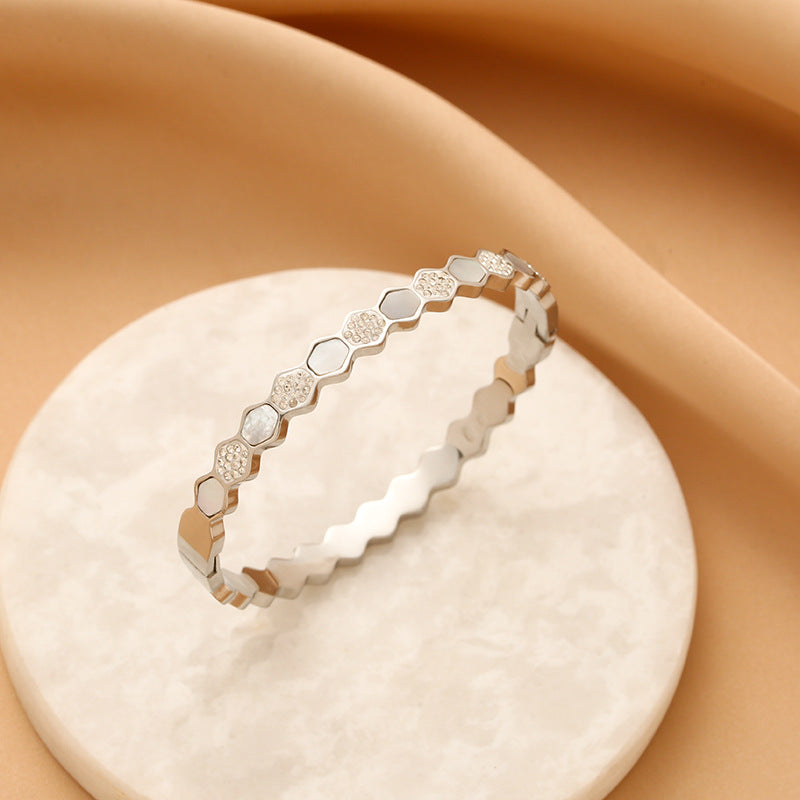 Hexagonal rose gold-tone titanium bracelet with zircons